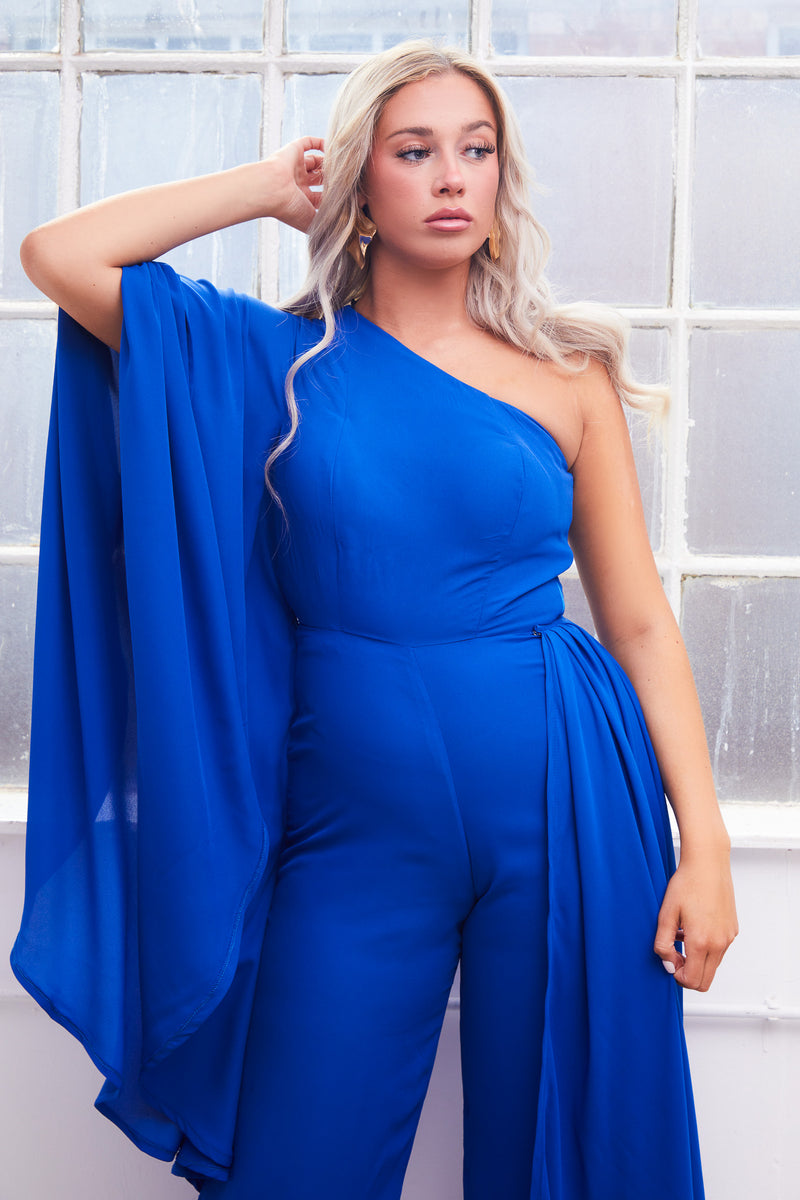 ODESSA  royal blue one sleeve winged jumpsuit with detachable side train